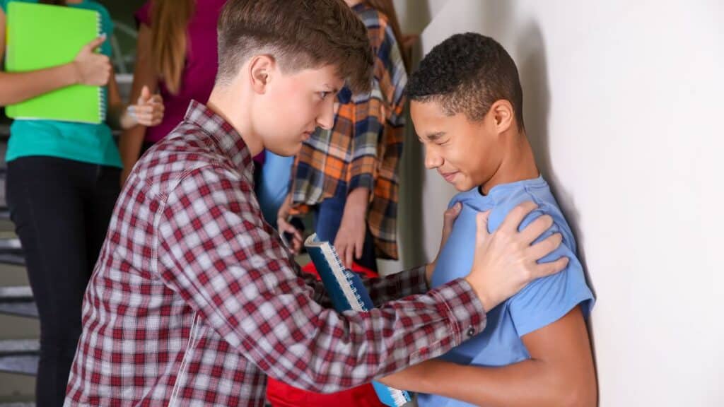 criança praticando bullying na escola 