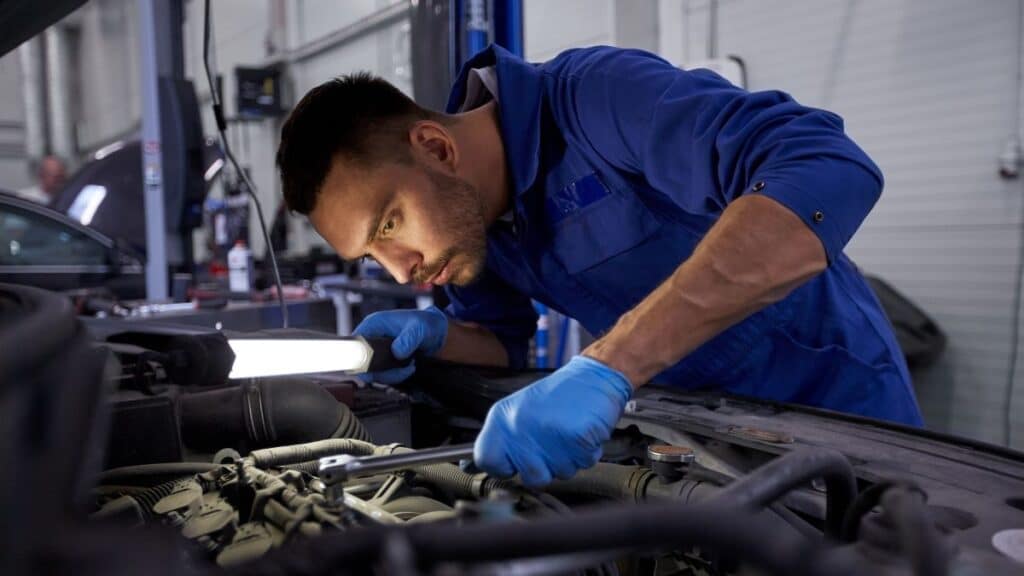 mecânico verificando motor em manutenção